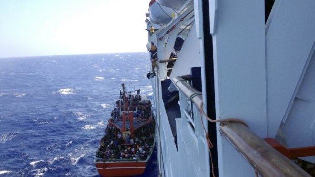 A photo taken from a cruise ship that rescued the migrants from a small boat stranded off the east Mediterranean island's main Limassol port, Cyprus, shows hundreds on the boat.