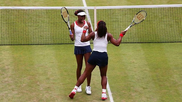 Victorious ... Venus, left, and Serena Williams celebrate their win.
