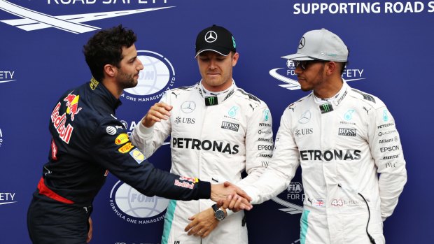 Ricciardo with Mercedes' Nico Rosberg of Germany and Lewis Hamilton of Great Britain.