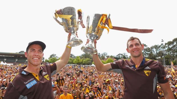 Coach Alastair Clarkson and captain Luke Hodge hold up the 2013 and 2014 premiership cups during the Hawthorn celebrations at Glenferrie Oval.