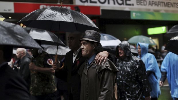 Tjhe show must go on - veterans march in a wet Anzac Day parade.