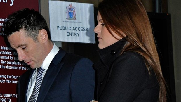 Stephen Milne outside Melbourne Magistrates Court, accompanied by wife Melissa, in July.