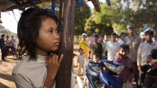 Rochom P'ngieng, is watched by locals at her rural home in 2007 in Oyadao, Cambodia.