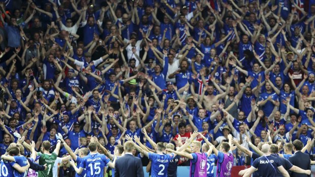 Iceland players celebrate their victory over England with the supporters in Nice last June.