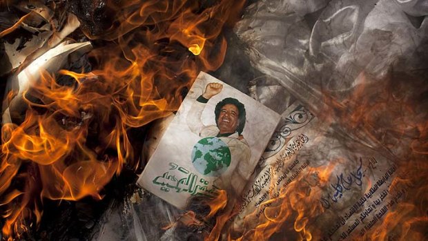 A book by Gaddafi burns during a protest in Benghazi.