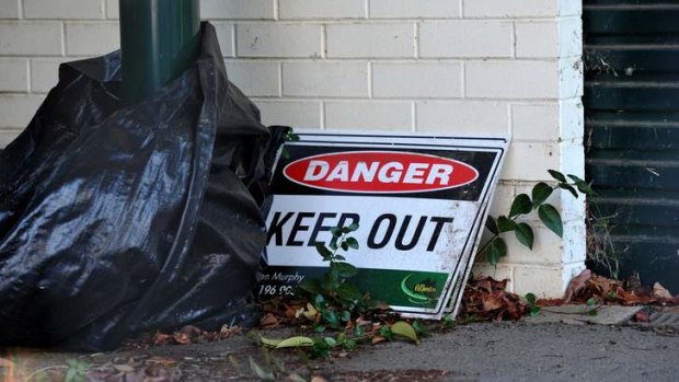 A sign sits outside of the Bradfield Street house that is due to be demolished because of the asbestos it contains.