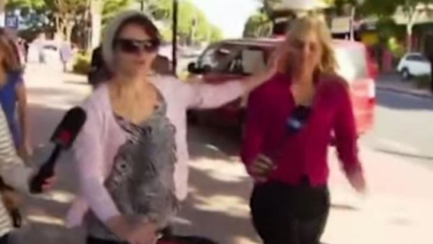 Reporter Alex Bernhardt recoiled after the woman stubbed her lit cigarette in her face.