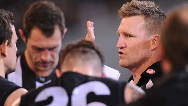 Collingwood's coach Nathan Buckley talks to the troops at quarter-time at the MCG.