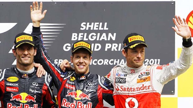 Mark Webber, Sebastian Vettel and Jenson Button celebrate on the podium after the Belgian Grand Prix.