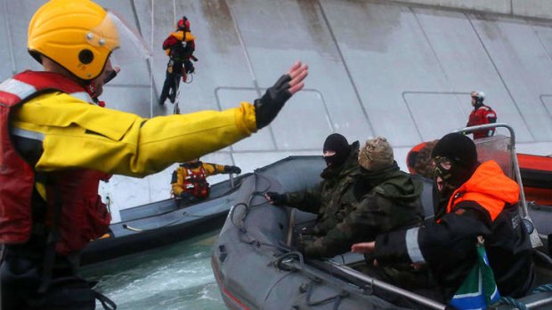 The Russian coast guard stops Greenpeace activists from climbing a Gazprom oil platform in the Arctic last month.
