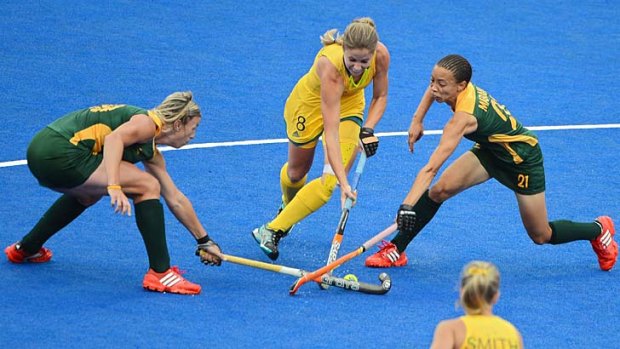 South Africa's Tarryn Bright and Lenise Marais tackle Hockeyroo Ashleigh Nelson.