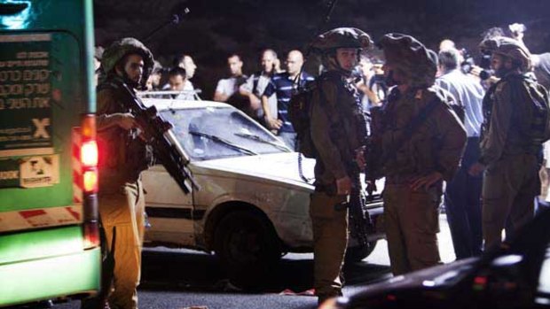Israeli soldiers at the scene of the attack.