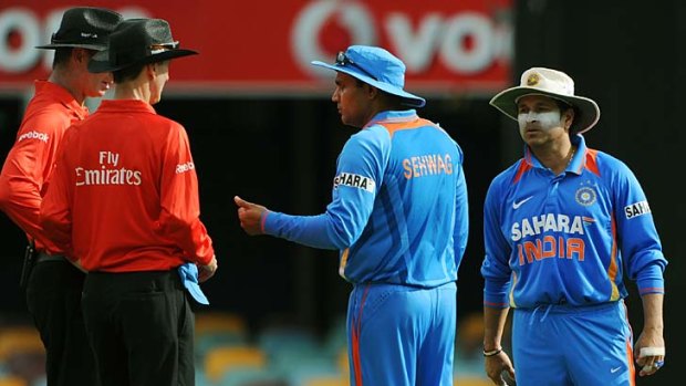 Indian captain Virender Sehwag (second from right) and Sachin Tendulkar (right), speak to umpires Paul Reiffel (left) and Billy Bowden after Ravi Aswhin ran out Lahiru Thirimanne for backing up too far.