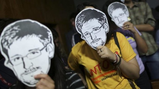 Behind the mask: Edward Snowden's revelations forced the issue of court authorisation for surveillance into the open.