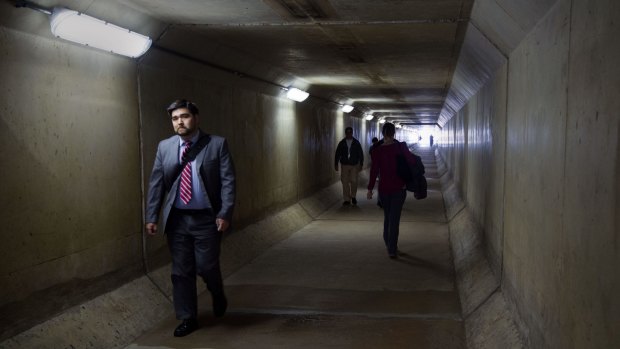 Alarm: Pentagon workers walk through a pedestrian tunnel in the South Parking lot area that crosses under Interstate 95 highway during an Ebola scare.
