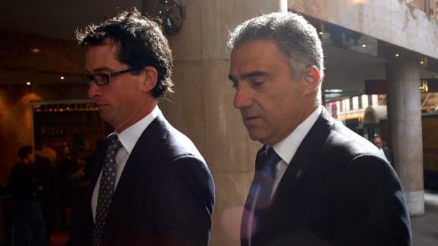 Paul Nicolaou, right, arrives at ICAC.