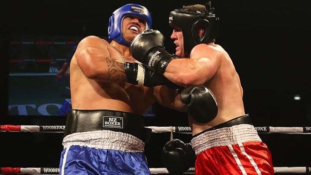Paul Gallen, right, punches Hika Elliott during the Fight for Life boxing night in Auckland.
