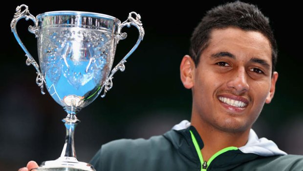 That-a-boy: Nick Kyrgios smiles after winning the Australian Open boys' final on Saturday.