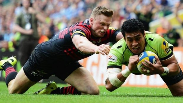 Chris Ashton of Saracens fails to stop George Pisi of Northampton Saints goes over to score their second try.