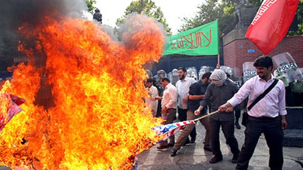Hardline Iranian students burn US and British flags during a protest outside the British embassy in Tehran.