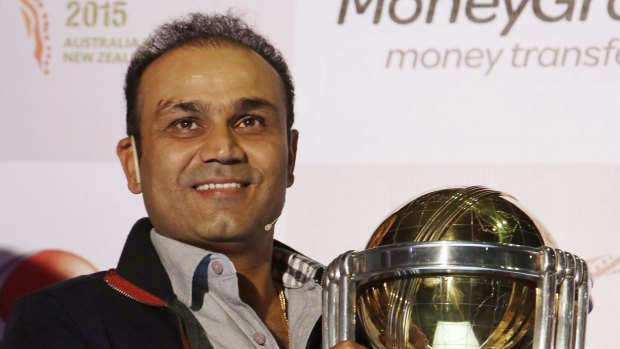 Virender Sehwag holds the ICC World Cup trophy in India in December 2014 ahead of the 2015 competition.