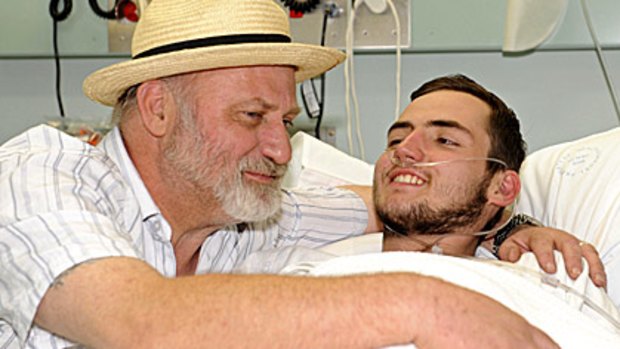 British backpacker Jamie Neale is embraced by his father Richard Cass at Katoomba Hospital.