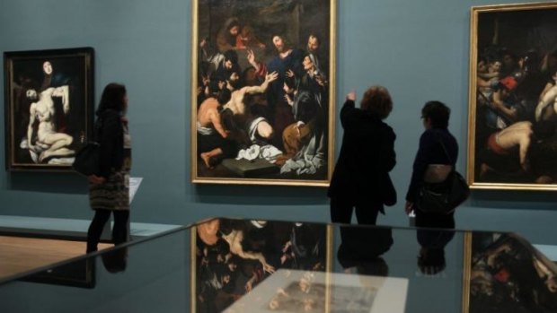 Gallery visitors survey some of the 100-odd works of art on display in <i>Italian Masterpieces from Spain's Royal Court</i>.