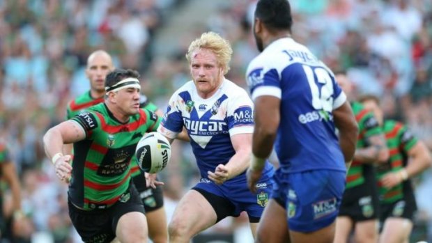 Canterbury prop James Graham passes the ball wide as the South Sydney defence closes in.
