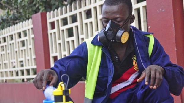 A man mixes disinfectant before spraying it on the streets in Monrovia, Liberia.