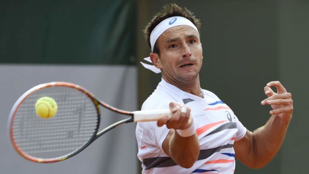 Tough loss ... Australia's Marinko Matosevic returns the ball to Great Britain's Andy Murray during their FrenchOpen second round match at the Roland Garros stadium in Paris.
