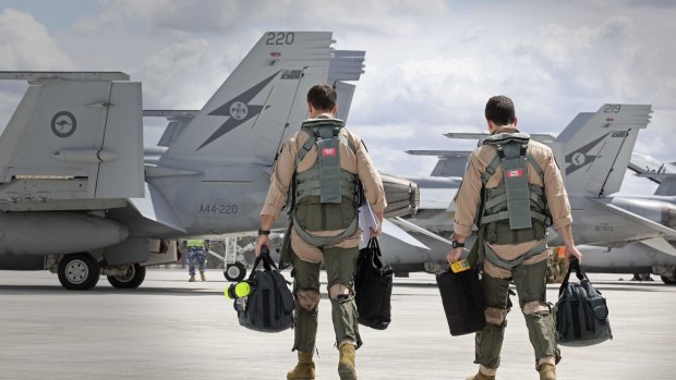 In this handout image provided by Commonwealth of Australia, F/A-18F Super Hornet aircrew head to their aircraft in preparation for departure to the Middle East from RAAF Base Amberley on September 21, 2014 in Amberley, Australia. 