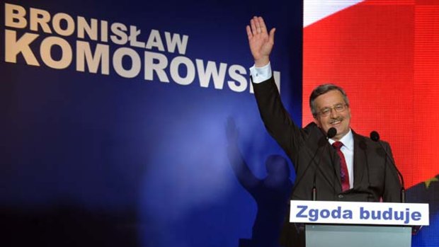 Presidential candidate Bronislaw Komorowski greets supporters in Warsaw.