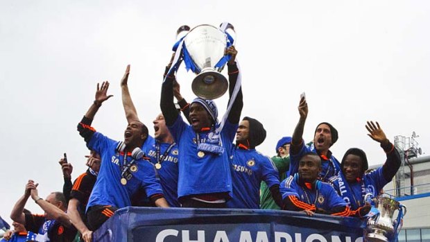 (L-R) Members of the Chelsea squad, English defender Ashley Cole, captain John Terry, Ivorian forward Didier Drogba, Portuguese defender Jose Bosingwa, Ivorian forward Salomon Kalou, and Portuguese mid-fielder Raul Meireles, celebrate with fans.