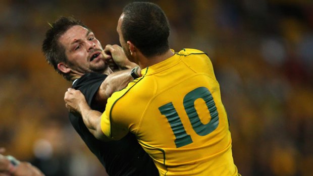 Lucky escape ... Quade Cooper has avoided a kneeing charge on All Blacks captain Richie McCaw.