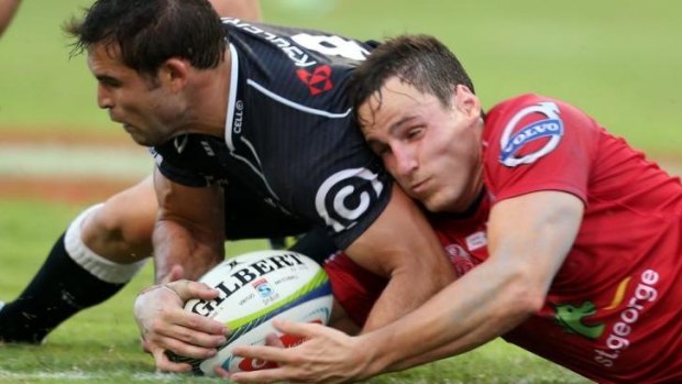 Fight for possession: Cobus Reinach of the Sharks and Mike Harris of the Reds.