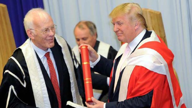 Sir Ian Wood, chancellor of Robert Gordon University, left, presents Donald Trump with his honorary degree.