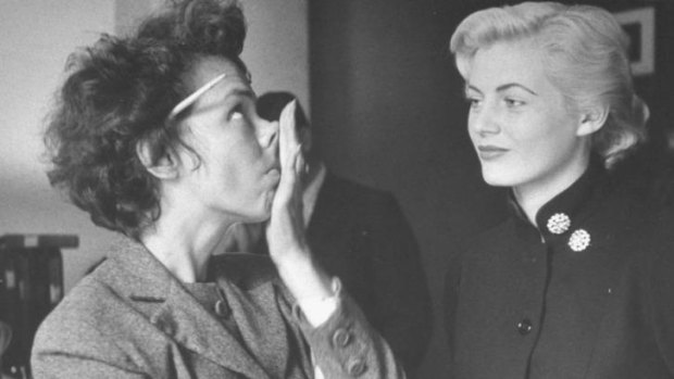 Anita Ekberg, 20, watches Eileen Ford demonstrate the nose tilt, a trick recommended for models just before they have their photo taken. 