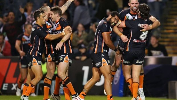 The Tigers celebrate a try at Campbelltown Sports Stadium on Saturday.