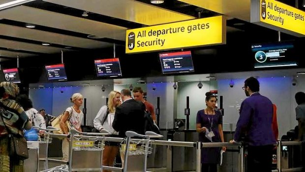 Passengers head towards security control at Heathrow airport in London.