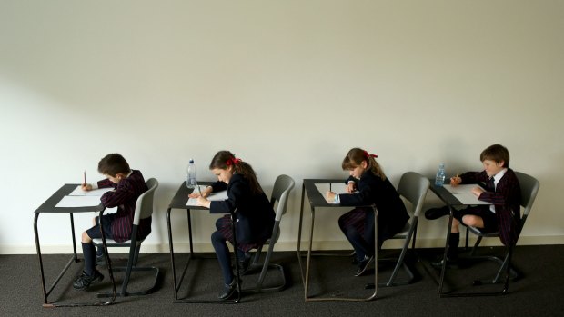 Students sit an exam.