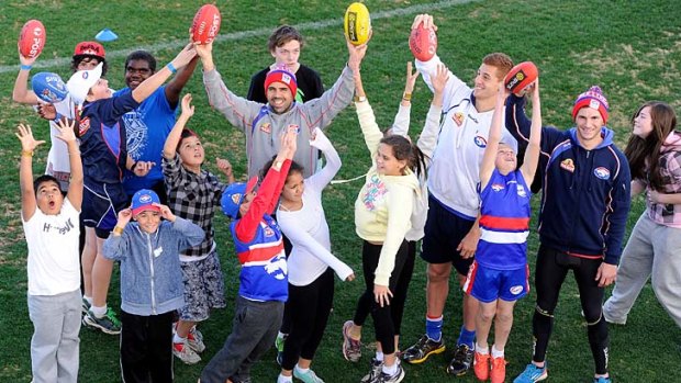 Bulldogs Brett Goodes, Liam Jones and Koby Stevens with Victorian indigenous kids from the Bulldogs Koori youth program at the Western Oval.