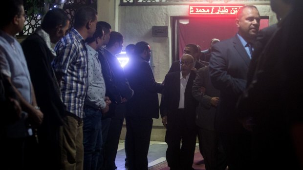 People line the exit of a memorial service for EgyptAir pilot Mohamed Saeed Shokair in Cairo on Sunday.