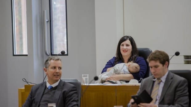 Giulia Jones makes history breastfeeding her son Maximus in the ACT Chamber on Tuesday, with Liberal colleagues Jeremy Hanson and Alistair Coe.