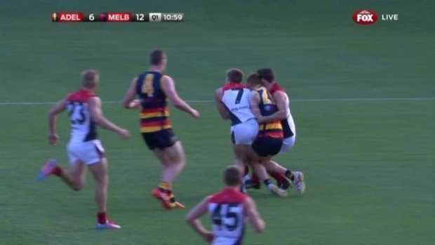 Melbourne's Jack Viney (number 7) collides with Crows Tom Lynch and Alex Georgiou in round seven.