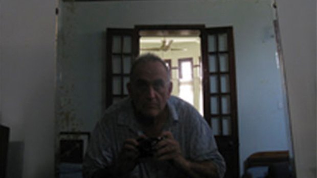 John  Yettaw taking a picture of himself  and the makeshift flippers he claimed to have used to swim across Inya Lake to Burmese opposition leader Aung San Suu Kyi's compound.