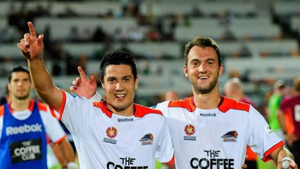 Brisbane Roar's Rocco Visconte and Ivan Franjic celebrate after defeating North Queensland Fury.