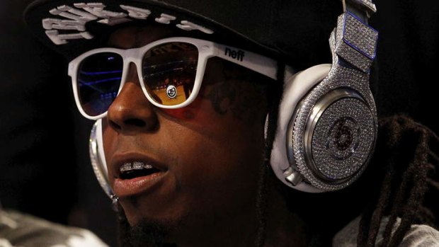 Rapper Lil' Wayne wears diamond-studded beats headphones.