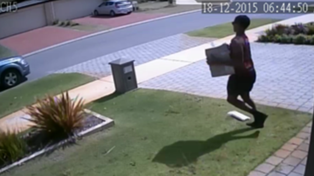 He can be seen taking the parcel back to his car