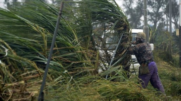 Gales: A man battles the wind as typhoon Vongfong approaches Okinawa, Japan.