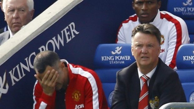 Forgettable start: Louis van Gaal (right) and assistant Ryan Giggs feel the pain against Leicester.